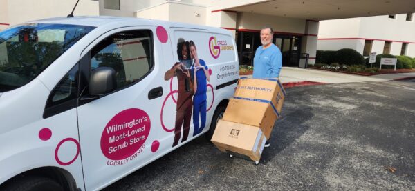 Greg's Uniforms van delivering a scrub order to a large office in Wilmington. Keeping it local helps your community.